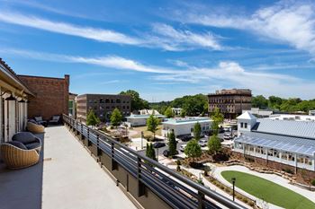 Rooftop clubroom with outdoor patio, catering kitchen, oversized dining table and communal living room with fireplace & tv